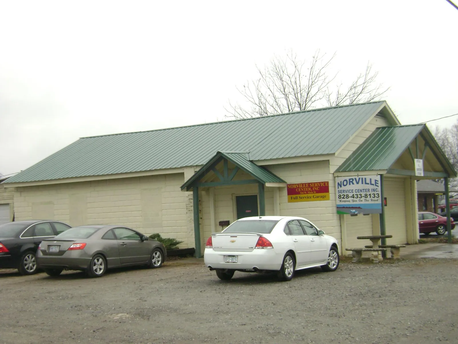Green metal roof on a service garage with a covered entry in Plainville